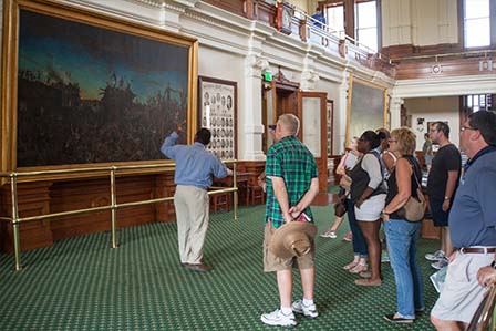 Capitol guide providing information to tour group about the Dawn at the Alamo painting.